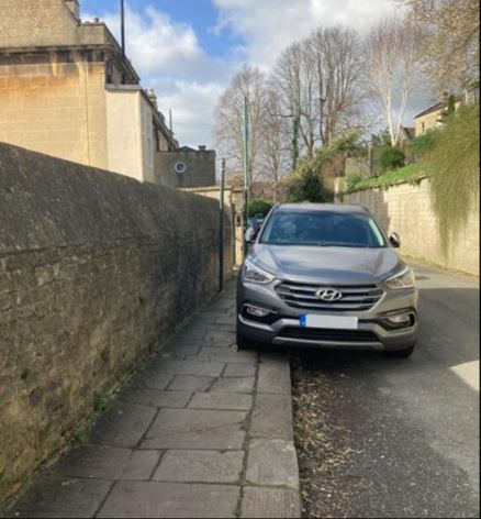 An image of a car parking on the pavement