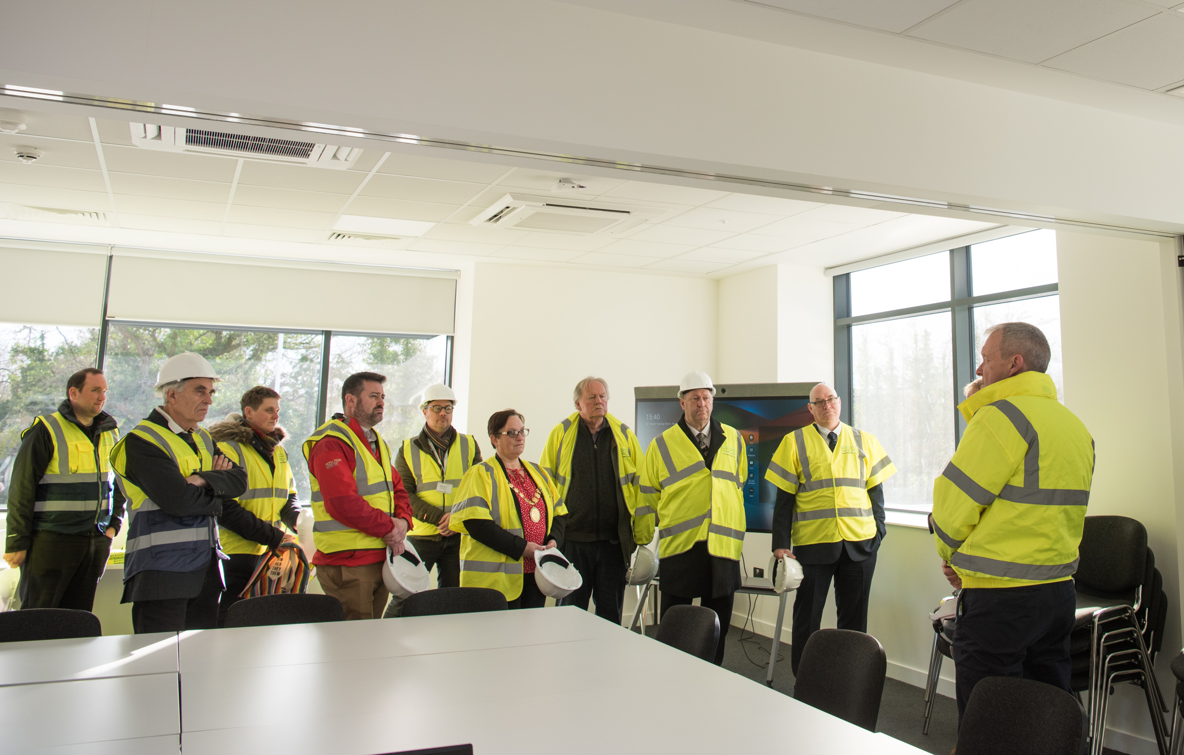 A picture of Councillors and Council staff in high-vis uniforms at the newly-opened Keynsham Recycling Hub