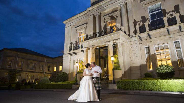 Wedded couple outside of Bath Spa Hotel at night